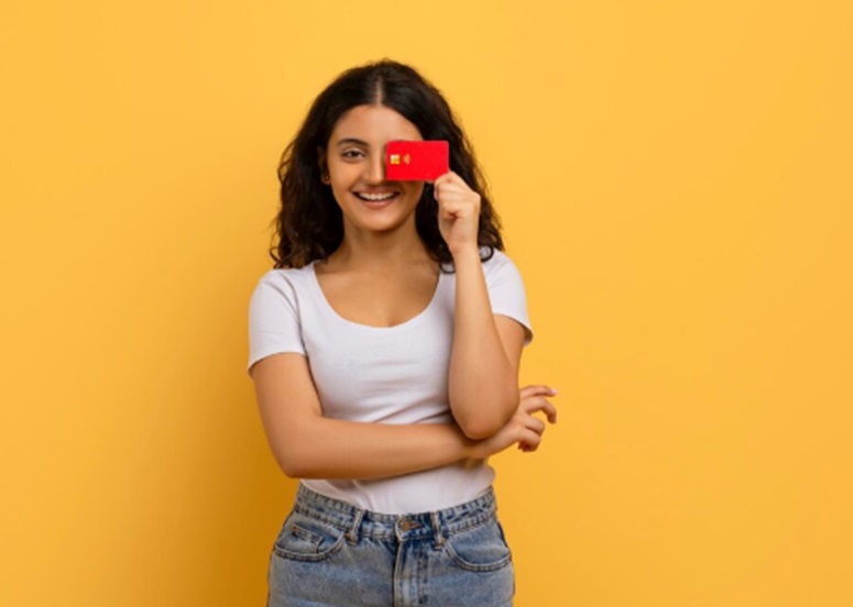 A woman holding an Insta EMI card.